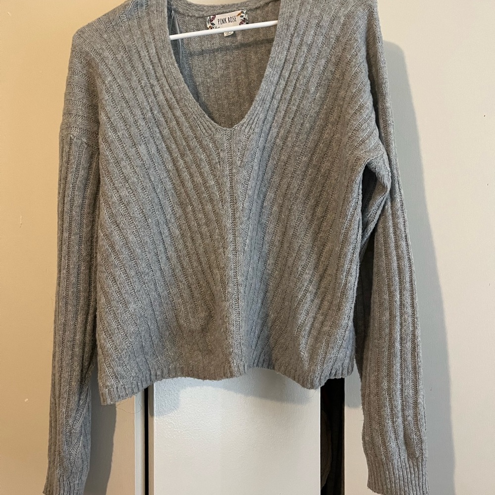 Gray sweater, made by Pink Rose. Size Medium. This is a cut-off style sweater